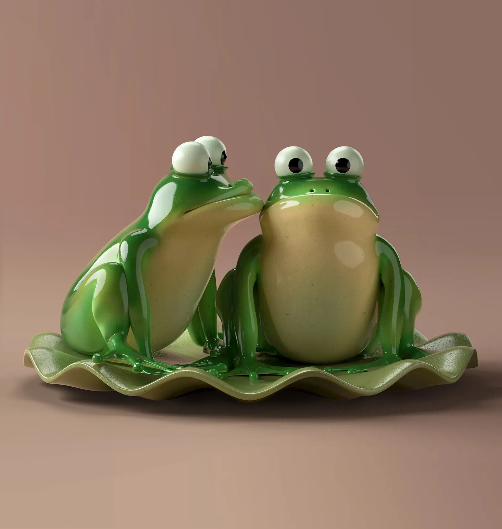 Styling_Stills29 Close-up of two glossy green ceramic frogs sitting together on a sculptural wavy tray against a soft rose pink background.